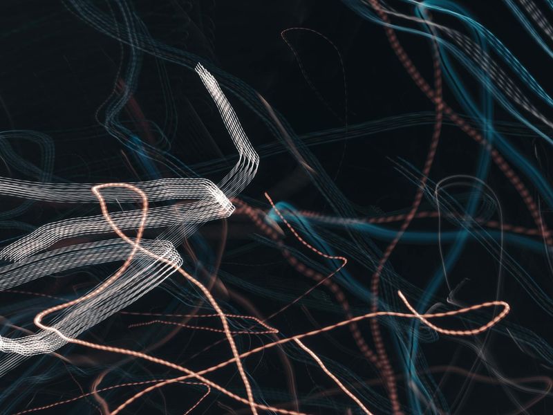 Athlete in mid-motion showing fluidity and grace against a dark background with blue light streaks.